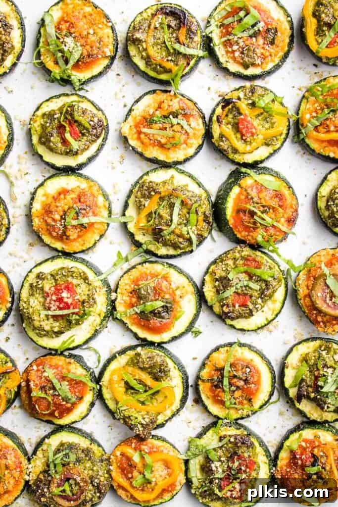 50 Quick Vegan Bites 34 Completed Zucchini Pizza Bites neatly lined up on a white surface, ready to be served.
