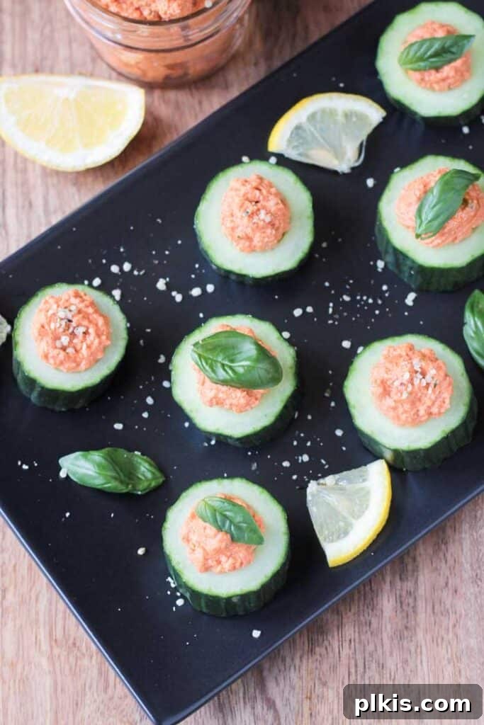 50 Quick Vegan Bites 36 Several refreshing Cucumber Bites scattered enticingly on a black serving tray.