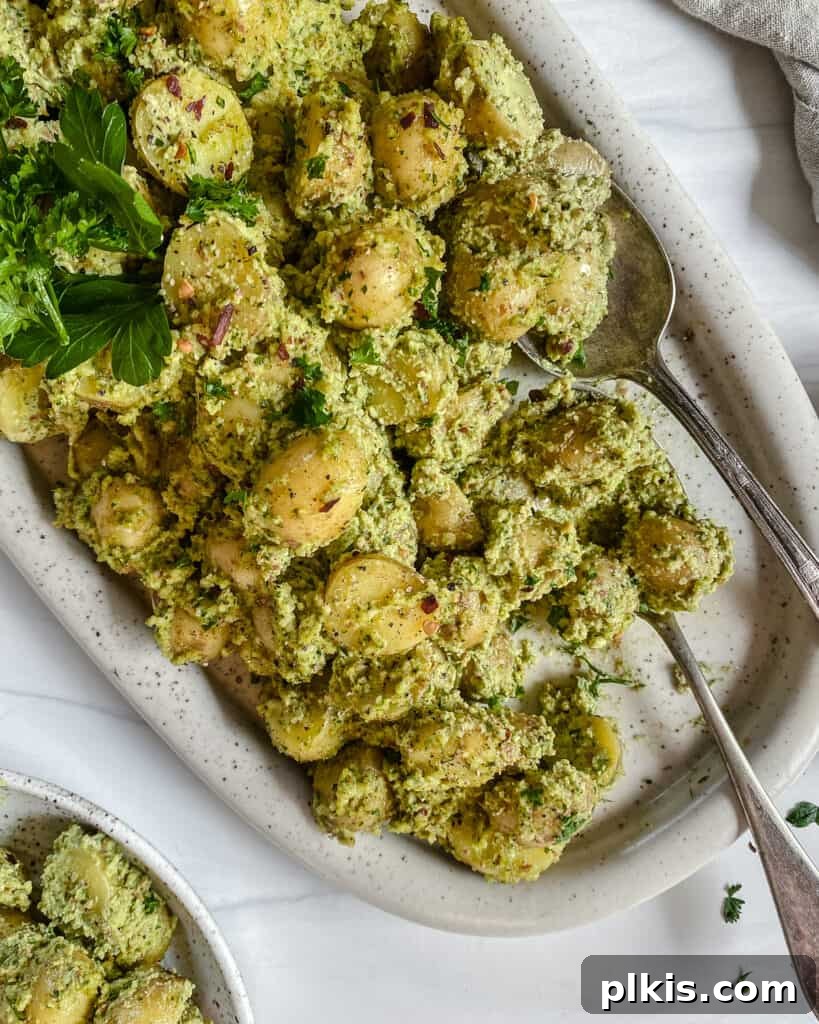 50 Quick Vegan Bites 58 Completed Almond Parsley Potatoes in a white baking dish against a clean white background.