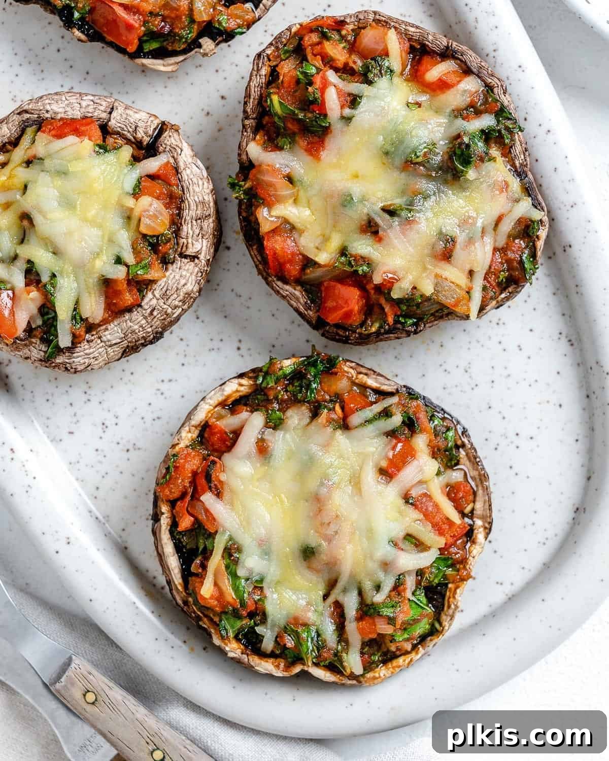 50 Quick Vegan Bites 70 Completed Portobello Mushroom Pizzas arranged in a white serving tray.