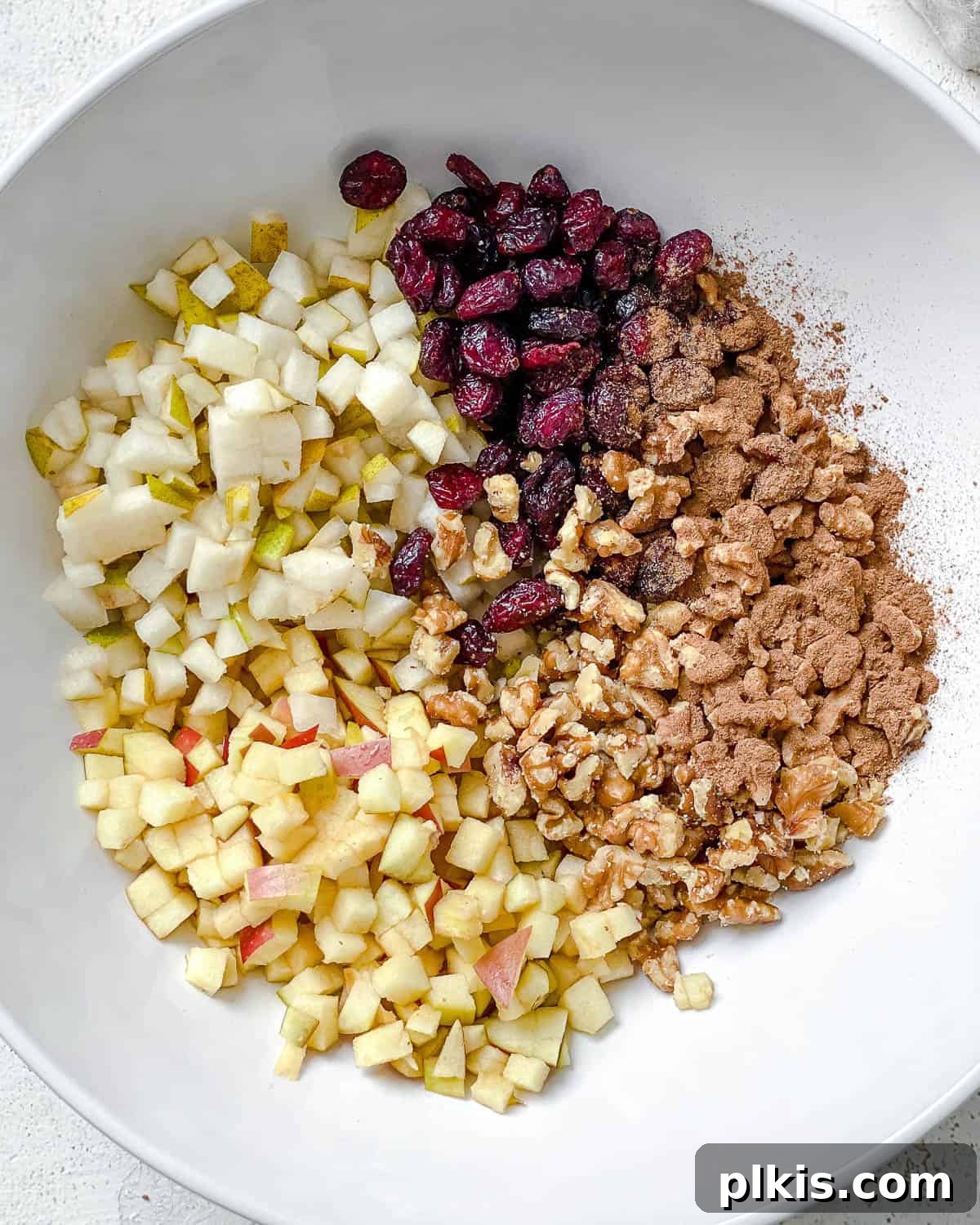 Rustic Charoset Delight 4 Process shot showing all ingredients for chopped charoset in a large white bowl, ready to be mixed.