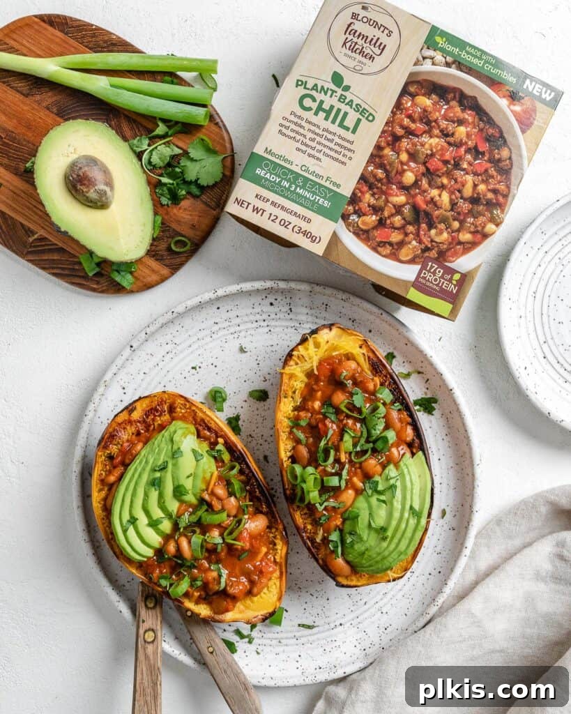Golden Spaghetti Squash Bowls with Spicy Chili Cheese 10 Chili cheese stuffed spaghetti squash in a white plate with Blount's chili packaging visible in the background.