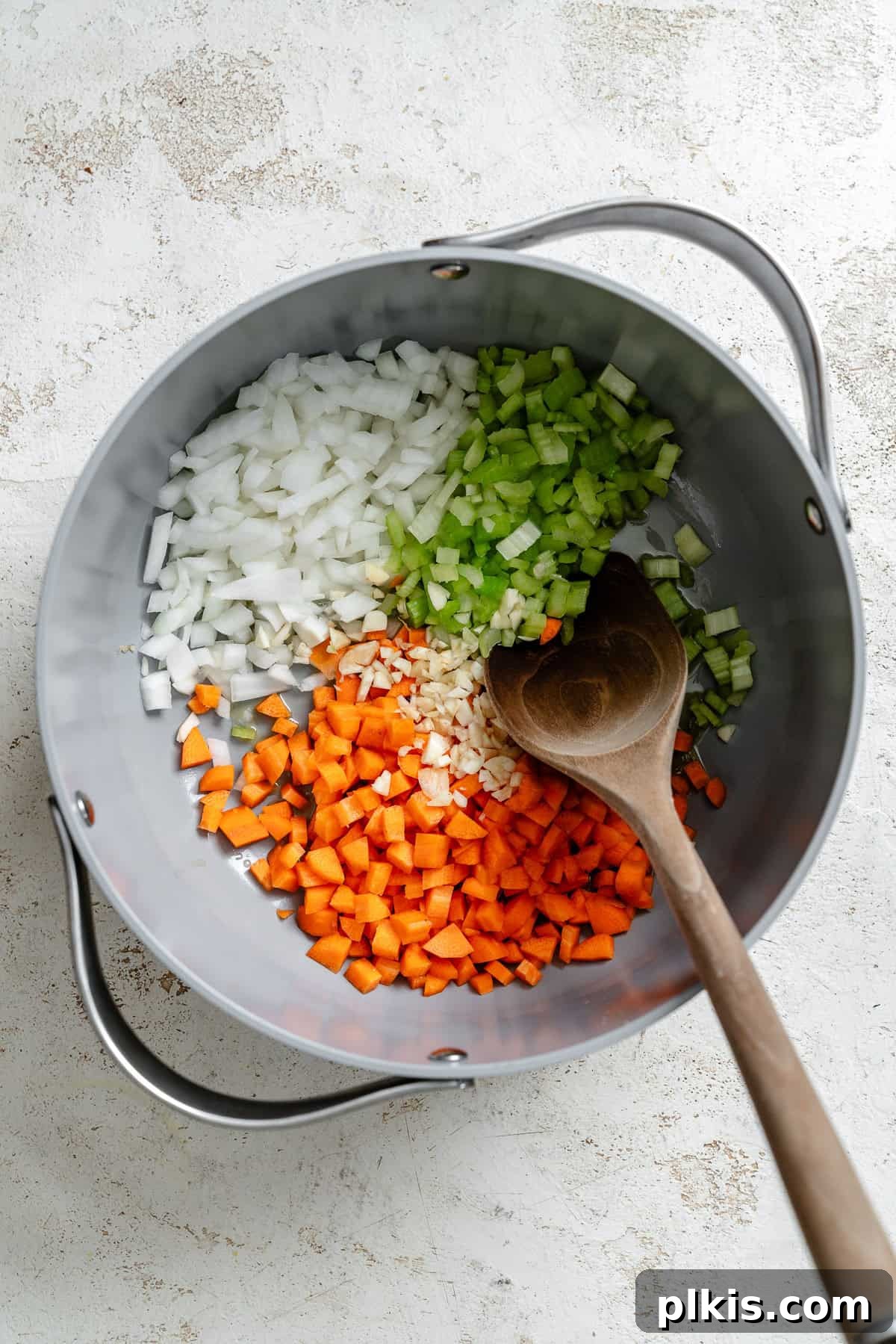 Hearty Barley and Bean Stew 4 Process shot showing stirring ingredients in a pot.