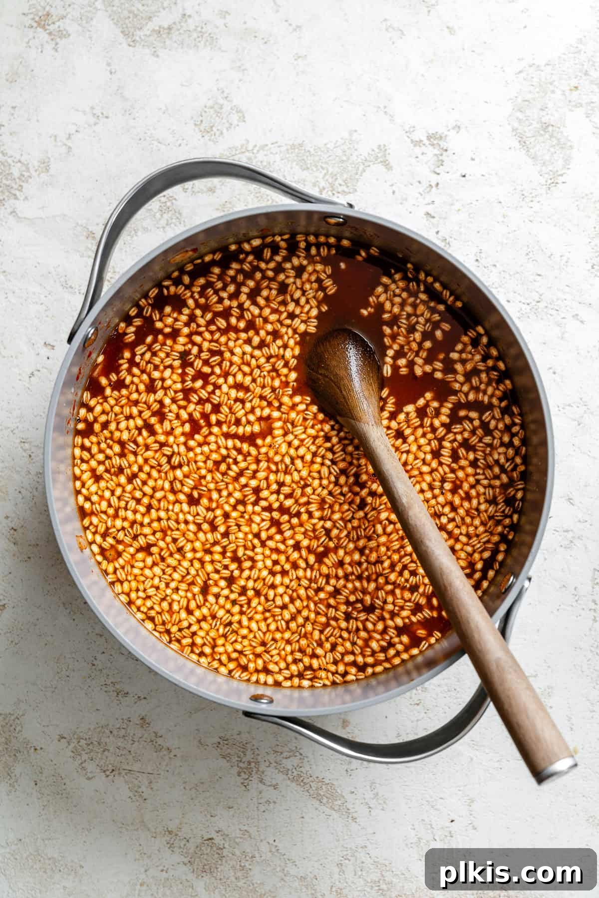 Hearty Barley and Bean Stew 6 Process shot showing using immersion blender in a pot.