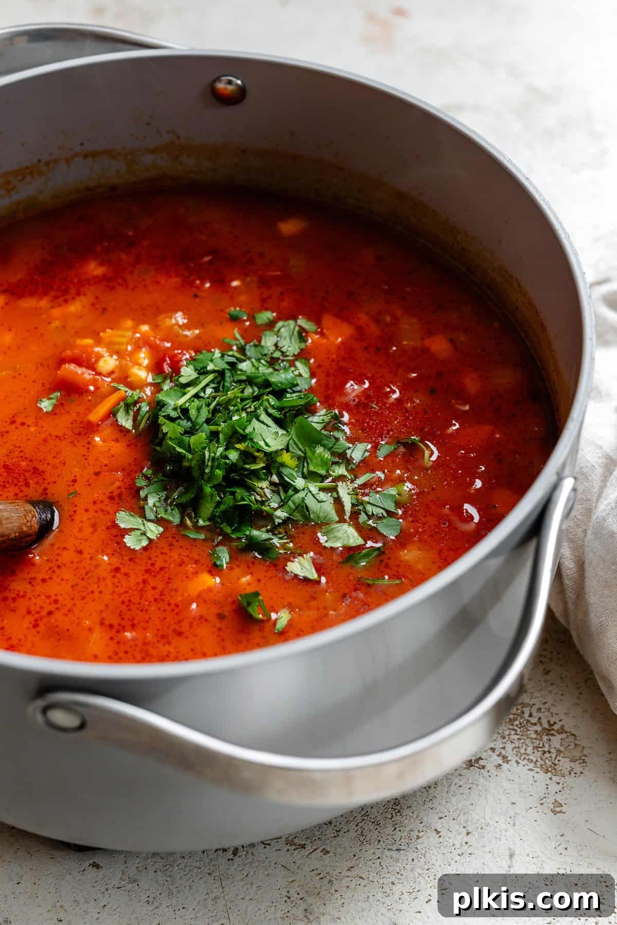 Hearty Barley and Bean Stew 7 Process shot showing cooking soup in a pot.