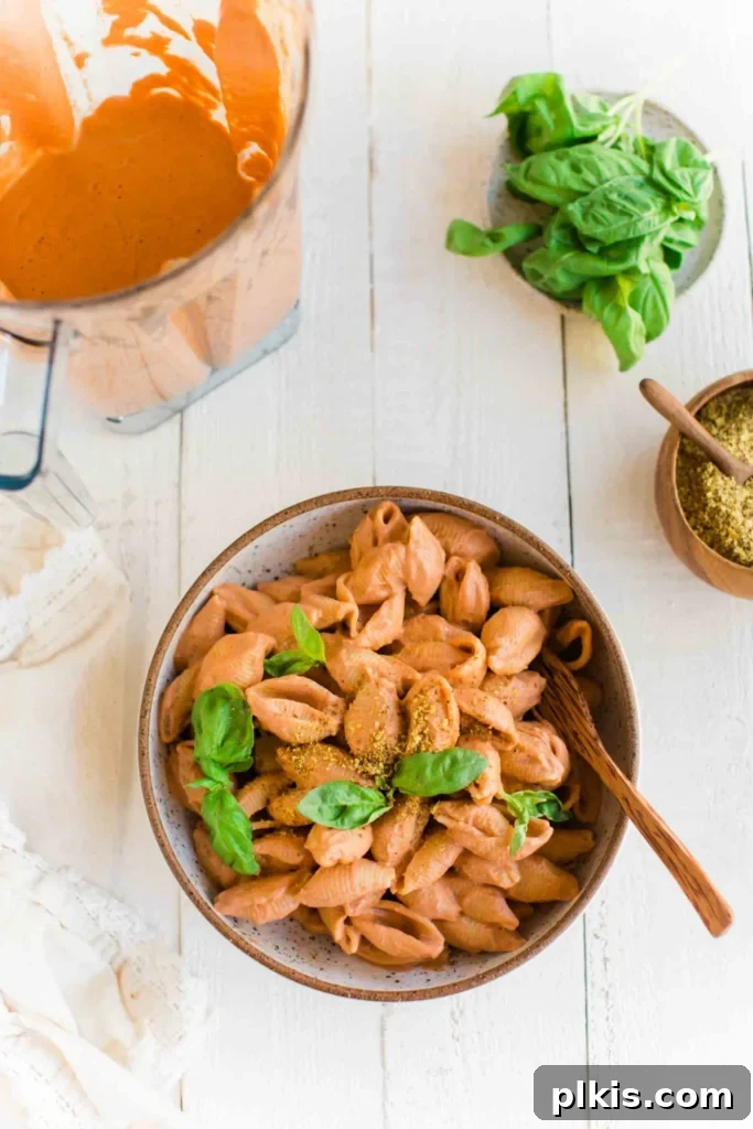 Quick & Delicious: 30-Minute Vegan Dinners 8 Completed pink pasta in a bowl with sauce and ingredients against a white background.