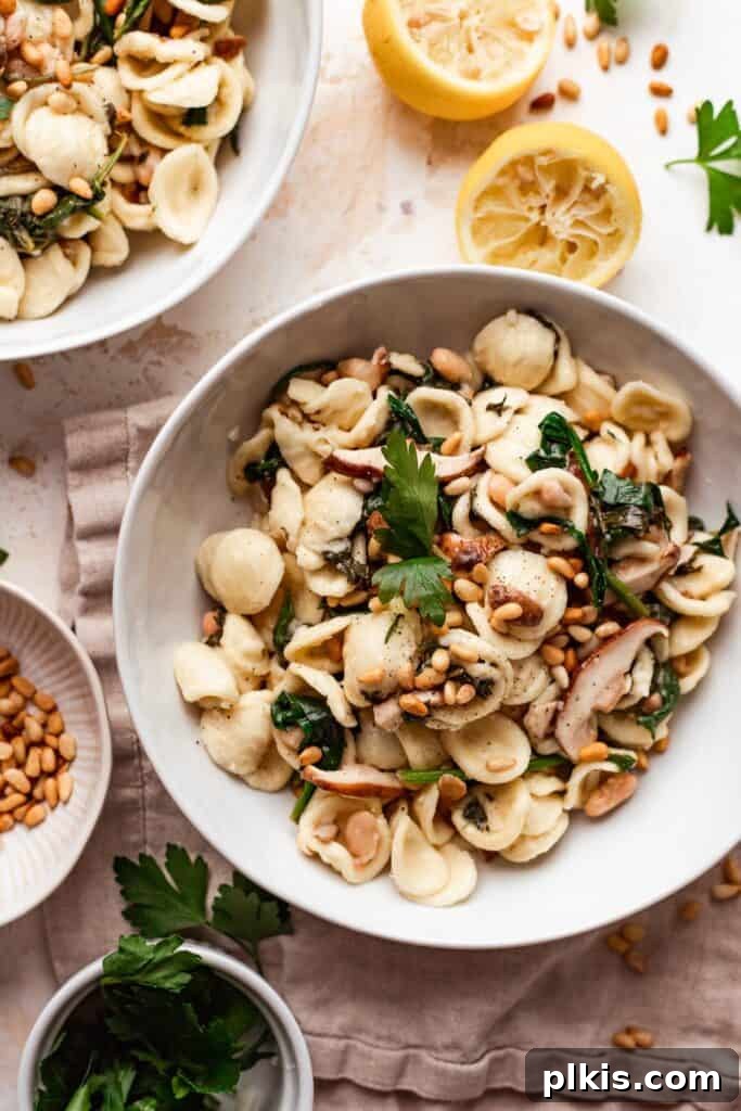 Quick & Delicious: 30-Minute Vegan Dinners 9 Completed mushroom pasta in a white bowl with various ingredients in the background.