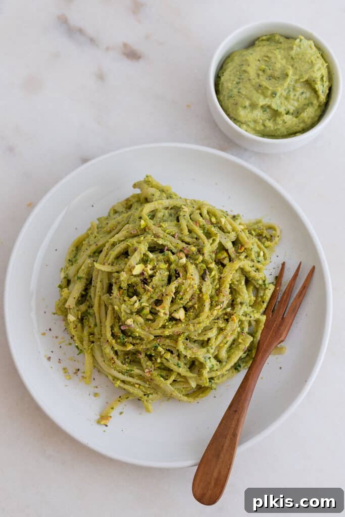 Quick & Delicious: 30-Minute Vegan Dinners 11 Completed avocado pesto plated on a white plate against a white background.