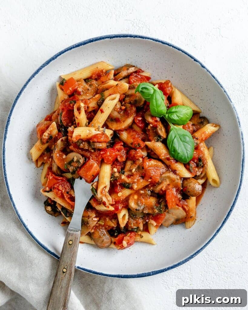 Quick & Delicious: 30-Minute Vegan Dinners 3 Completed Spicy Tomato Basil Pasta in a white plate against a white surface.