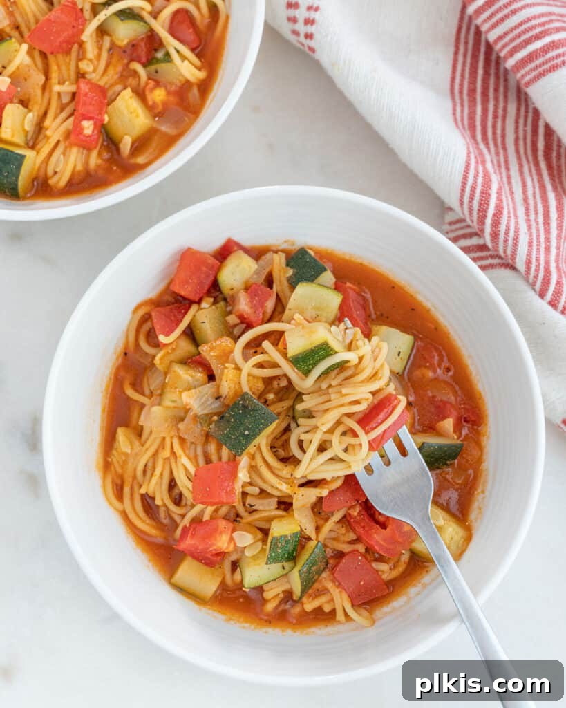 Quick & Delicious: 30-Minute Vegan Dinners 15 Completed Sopa de Fideo plated in two white bowls against white background.