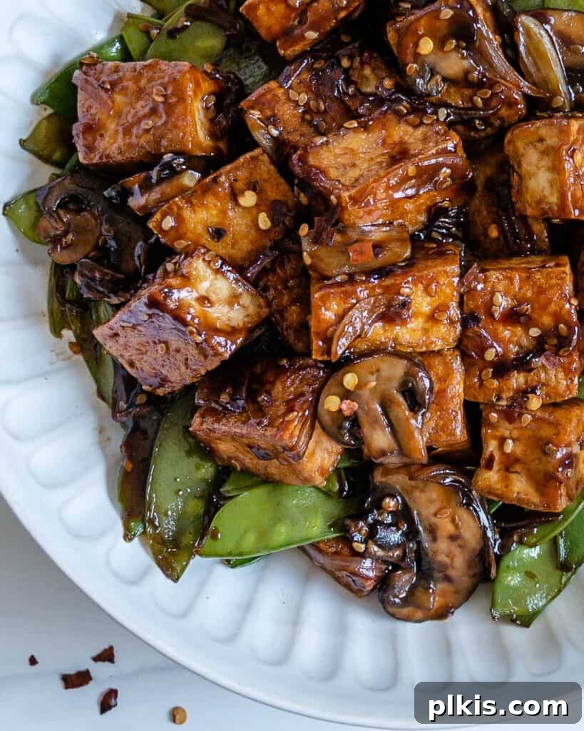 Quick & Delicious: 30-Minute Vegan Dinners 22 #completed Spicy Sesame Tofu Stir-fry plated on a white plate.