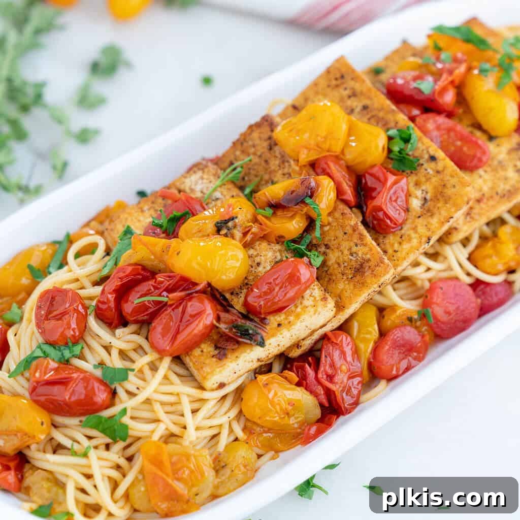 Quick & Delicious: 30-Minute Vegan Dinners 26 Completed Tofu Fillets with Tomato Herb Sauce in a white serving platter against a white background.