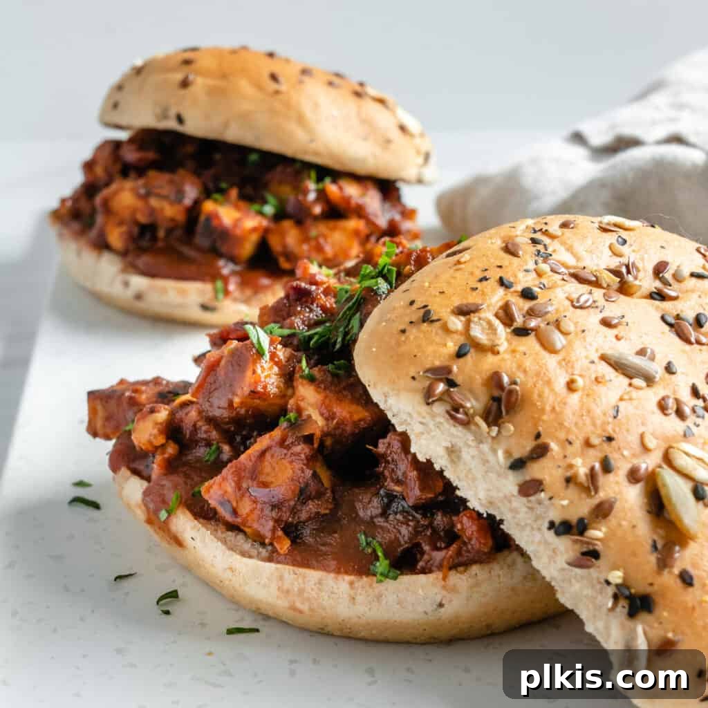 Quick & Delicious: 30-Minute Vegan Dinners 28 Two completed BBQ Tempeh Sandwiches against a white surface.