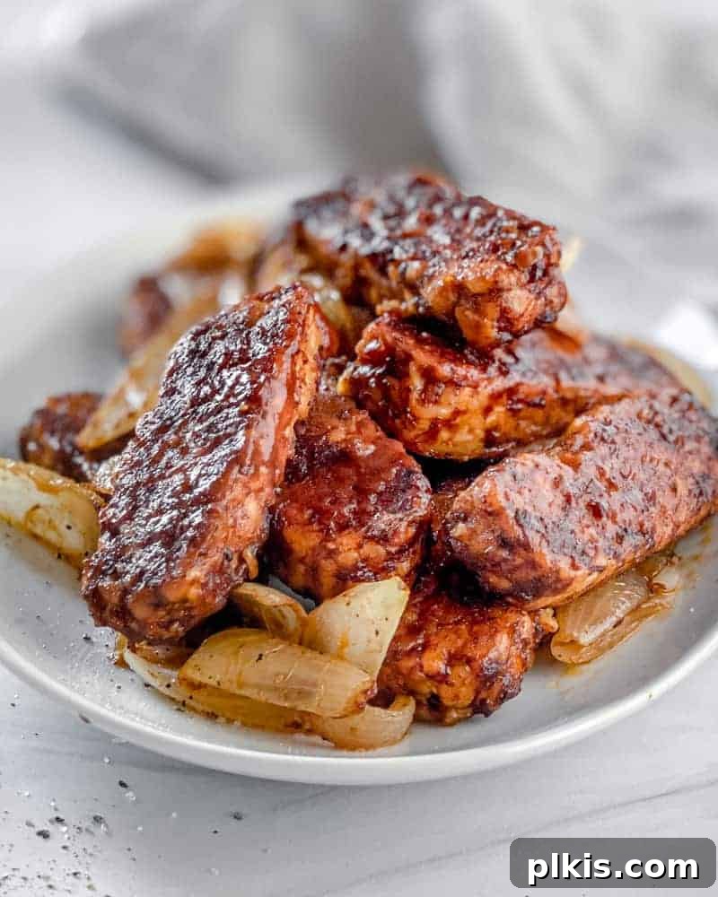 Quick & Delicious: 30-Minute Vegan Dinners 29 Completed BBQ Tempeh plated on a white plate against a light background.