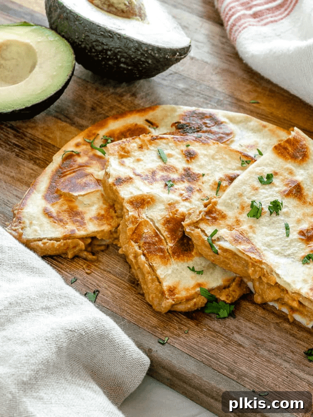 Quick & Delicious: 30-Minute Vegan Dinners 32 Completed vegan bean quesadillas on a brown surface with avocados in the background.
