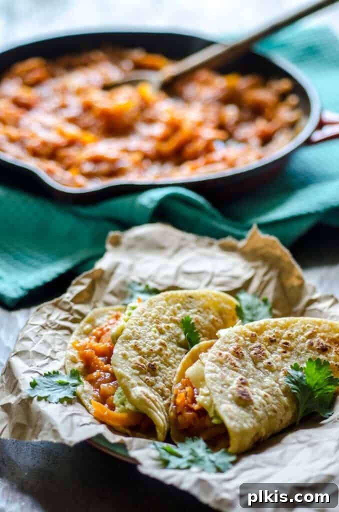 Quick & Delicious: 30-Minute Vegan Dinners 33 Completed Sweet Potato and Carrot Tinga Tacos plated with filling in the background.