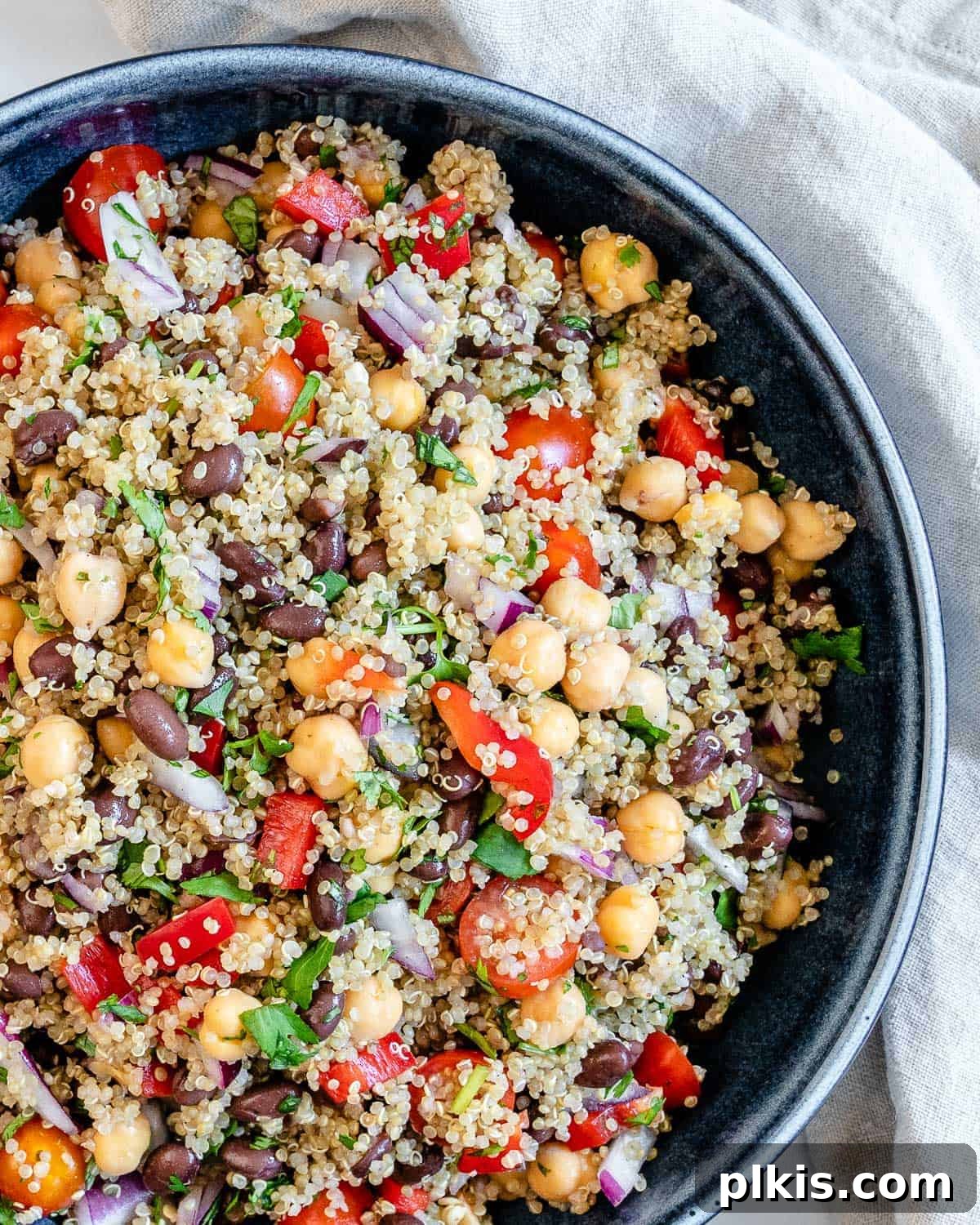Quick & Delicious: 30-Minute Vegan Dinners 41 Completed Fresh Quinoa Salad in a blue bowl against a white background.