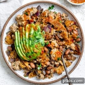 A plate of colorful Vegan Chilaquiles, topped with fresh ingredients.