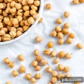 Crispy air fryer chickpeas, both scattered on a surface and piled in a bowl.