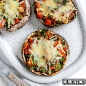 Portobello mushroom pizzas, baked in a white serving tray.