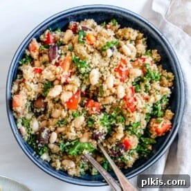 A blue bowl filled with vibrant Lemon Garlic Quinoa, served warm or cold.