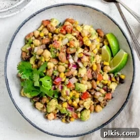 A white plate featuring Texas Caviar, also known as Avocado Corn and Bean Salad.