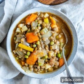 A white bowl of hearty Root Vegetable and Lentil Stew.