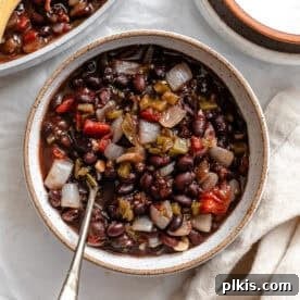 A bowl of rich black bean chili, perfect for a comforting meal.