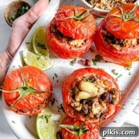 Stuffed tomatoes, beautifully plated on a white platter.