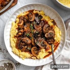 Creamy Polenta with Mushrooms, served on a plate.
