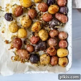 Roasted Rosemary Potatoes in a white tray, vibrant and aromatic.