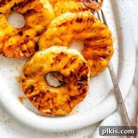 Easy Grilled Pineapple slices on a serving platter.