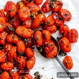 Easy Roasted Cherry Tomatoes on a white surface.