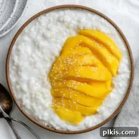 Thai Mango Sticky Rice on a white surface, vibrant and sweet.
