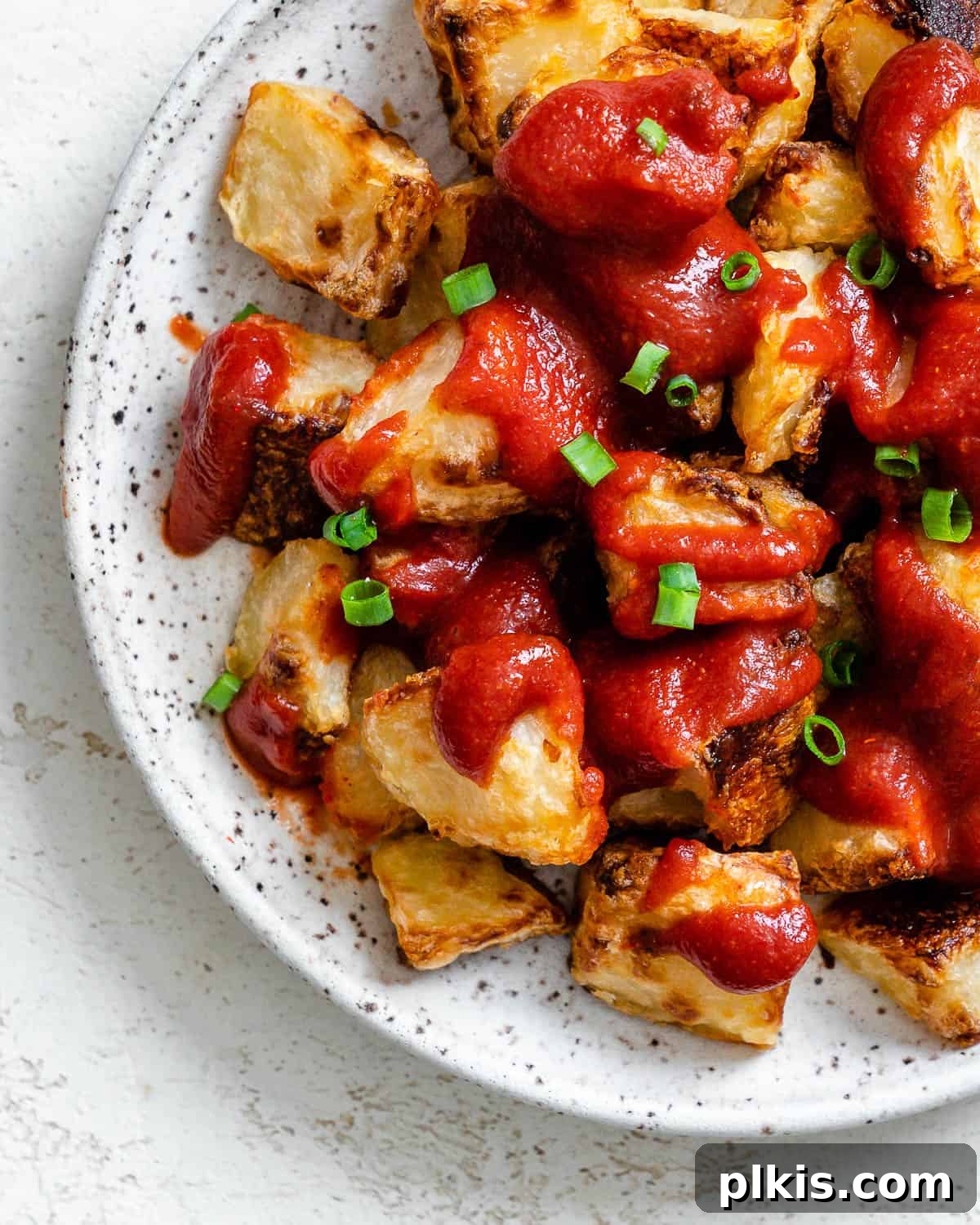 Healthy Patatas Bravas Roasted Sauteed Air Fried 2 completed Patatas Bravas plated on a white plate