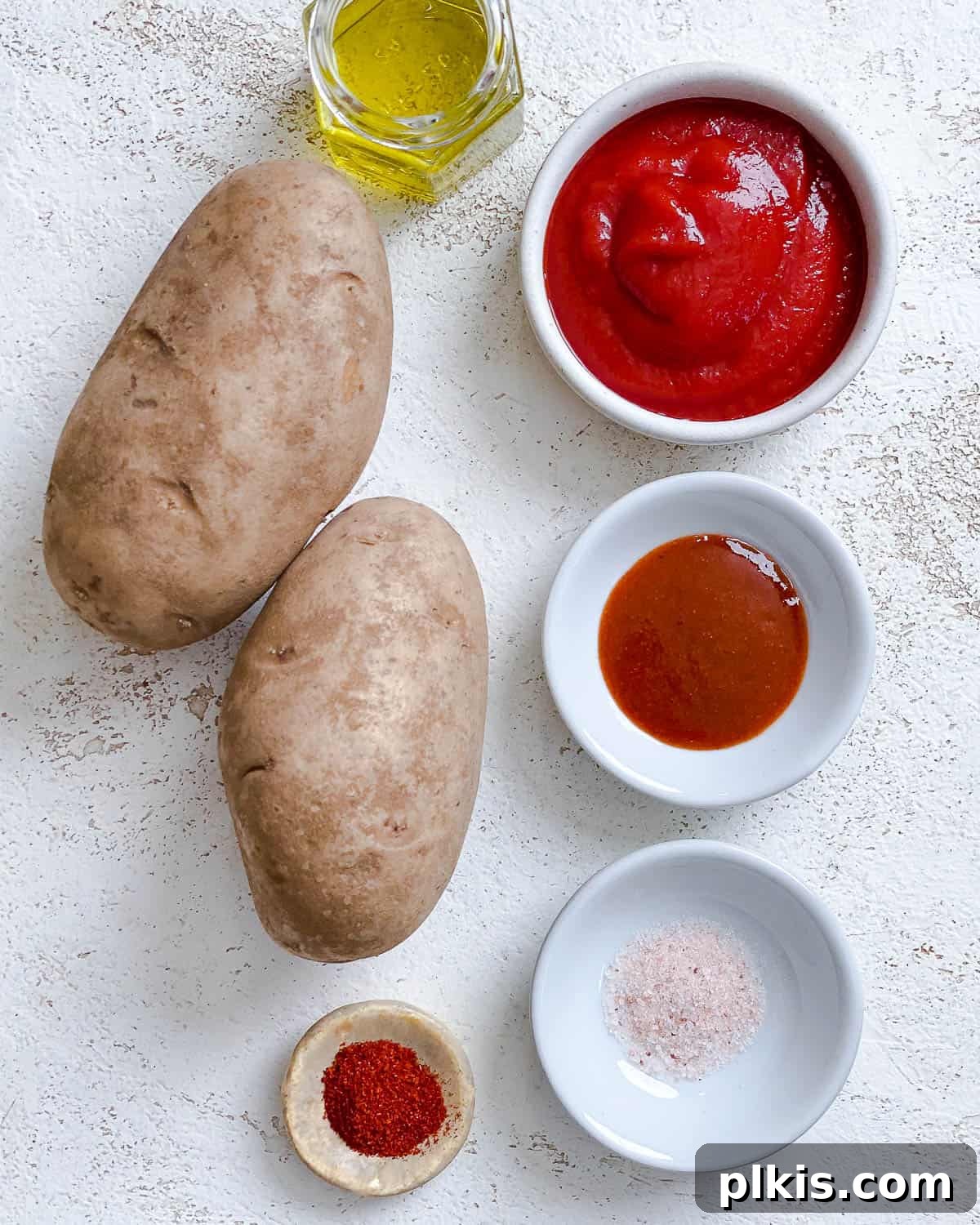Healthy Patatas Bravas Roasted Sauteed Air Fried 3 ingredients for Patatas Bravas measured out against a white surface
