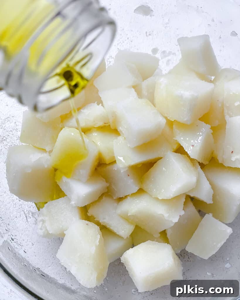 Healthy Patatas Bravas Roasted Sauteed Air Fried 6 process shot showing oil added to potatoes