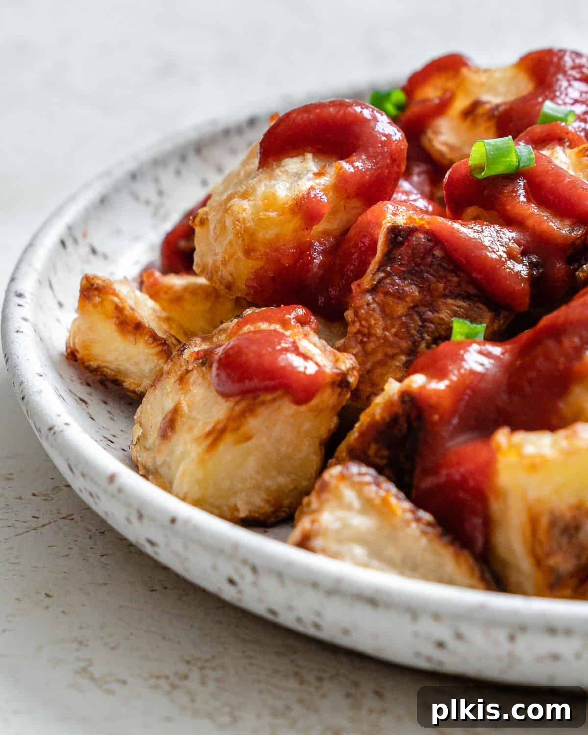 Healthy Patatas Bravas Roasted Sauteed Air Fried 9 completed Patatas Bravas plated on a white plate