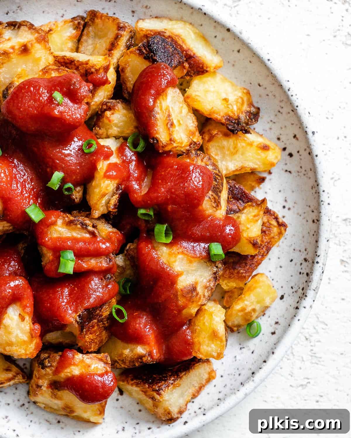 Healthy Patatas Bravas Roasted Sauteed Air Fried 10 completed Patatas Bravas plated on a white plate