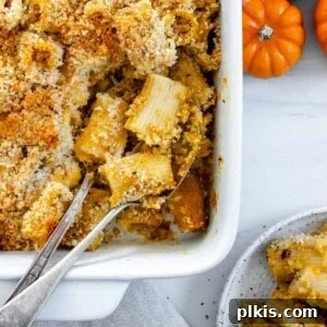 completed vegan pasta bake in a white dish with utensils in the dish