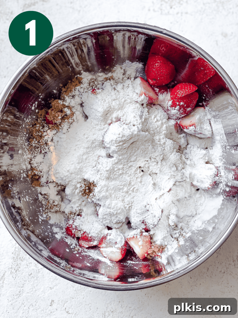 Luscious Vegan Strawberry Pie 4 Process shot showing addition of ingredients in a bowl for strawberry pie filling