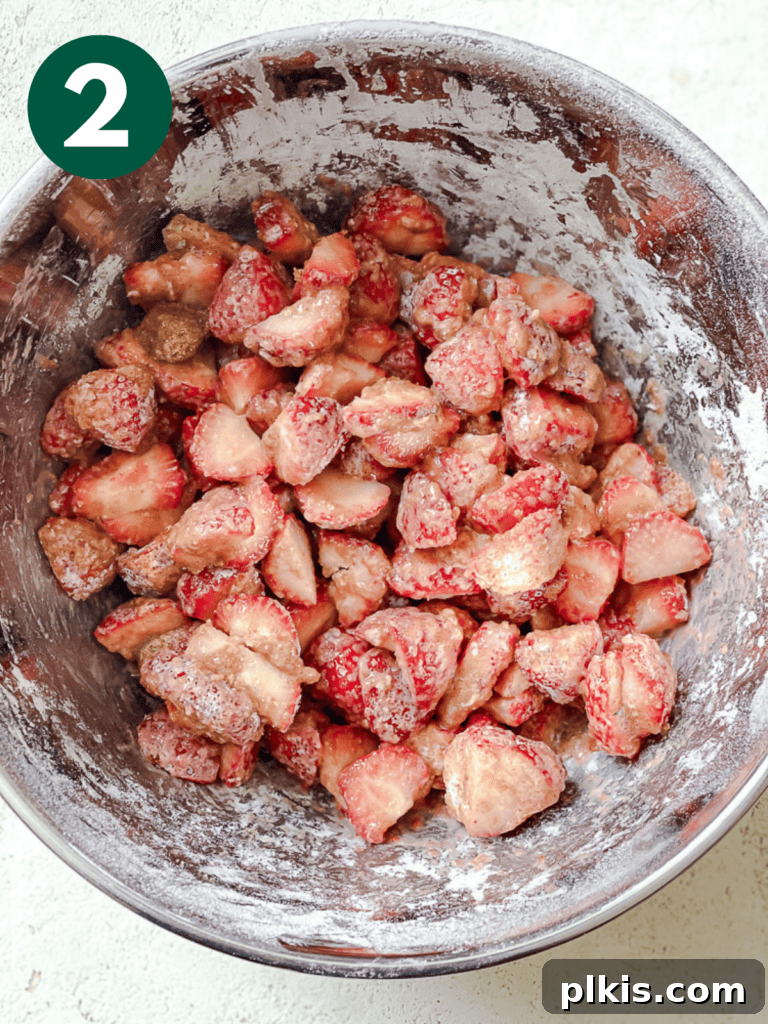 Luscious Vegan Strawberry Pie 5 Process shot showing the mixing of strawberry pie ingredients in a bowl