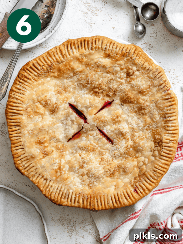 Luscious Vegan Strawberry Pie 9 Post-baked strawberry pie resting on a white surface, cooling down