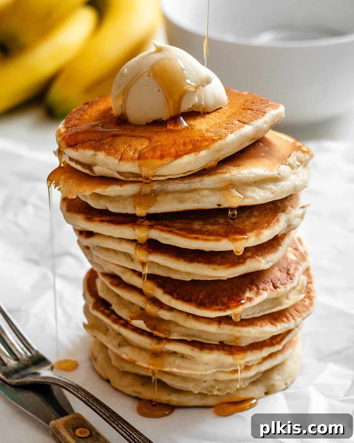 completed stack of pancakes against a white surface