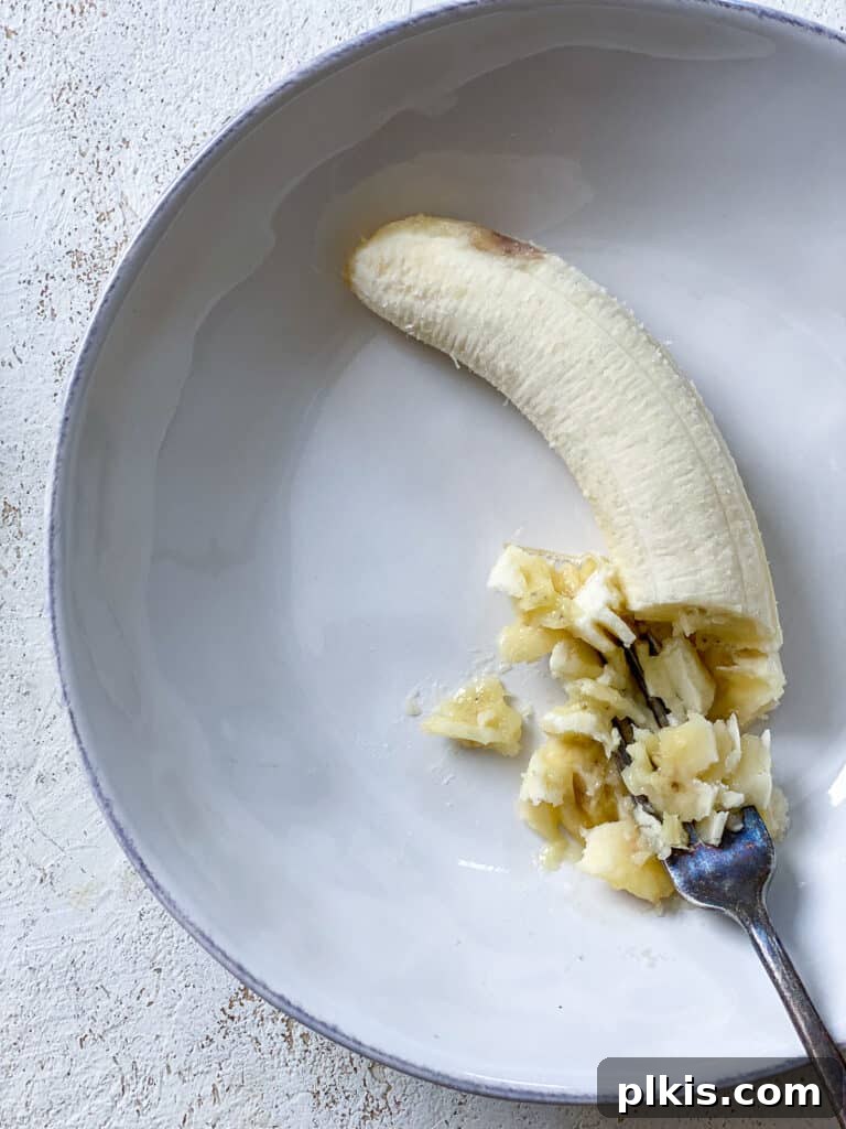 process shot of mashing banana on a plate