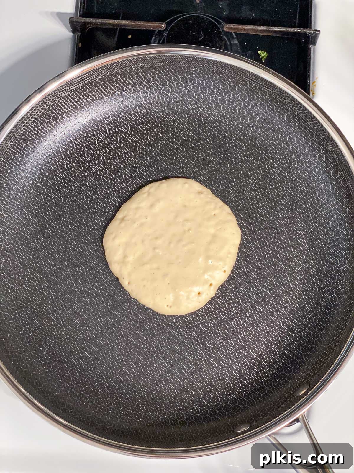 process shot of adding batter to skillet