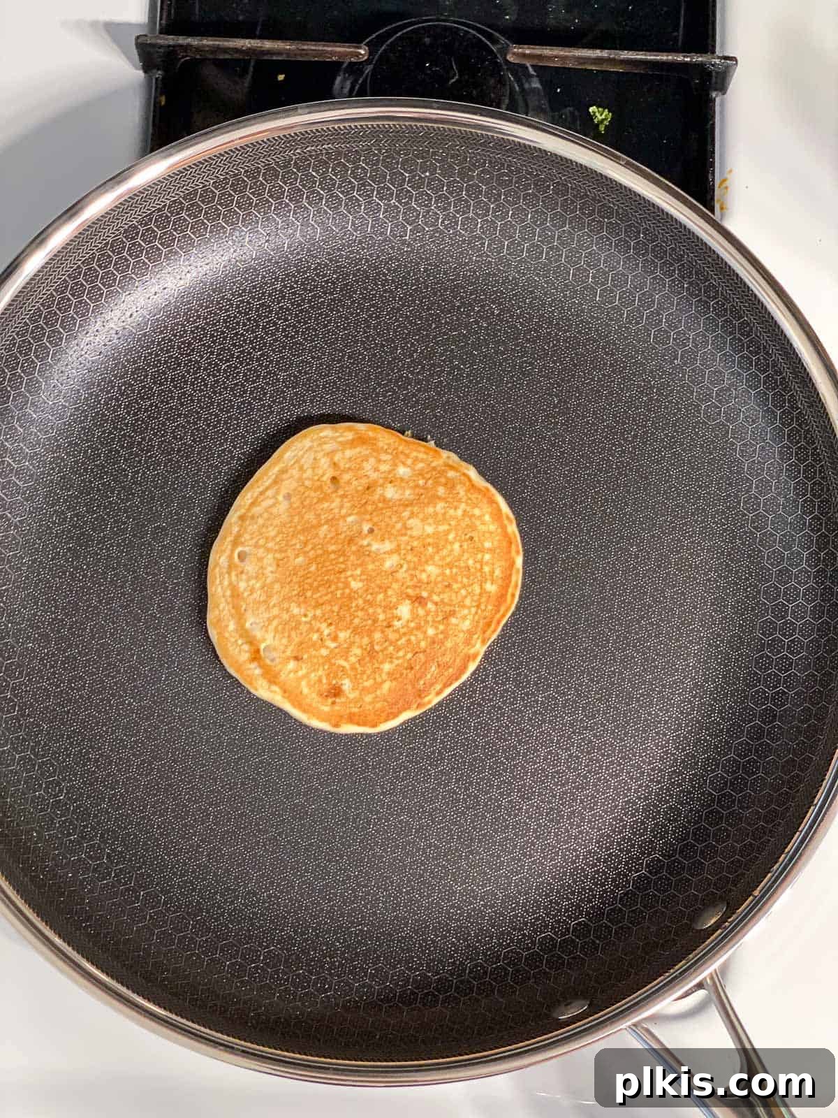 process shot showing flipped pancake on a skillet