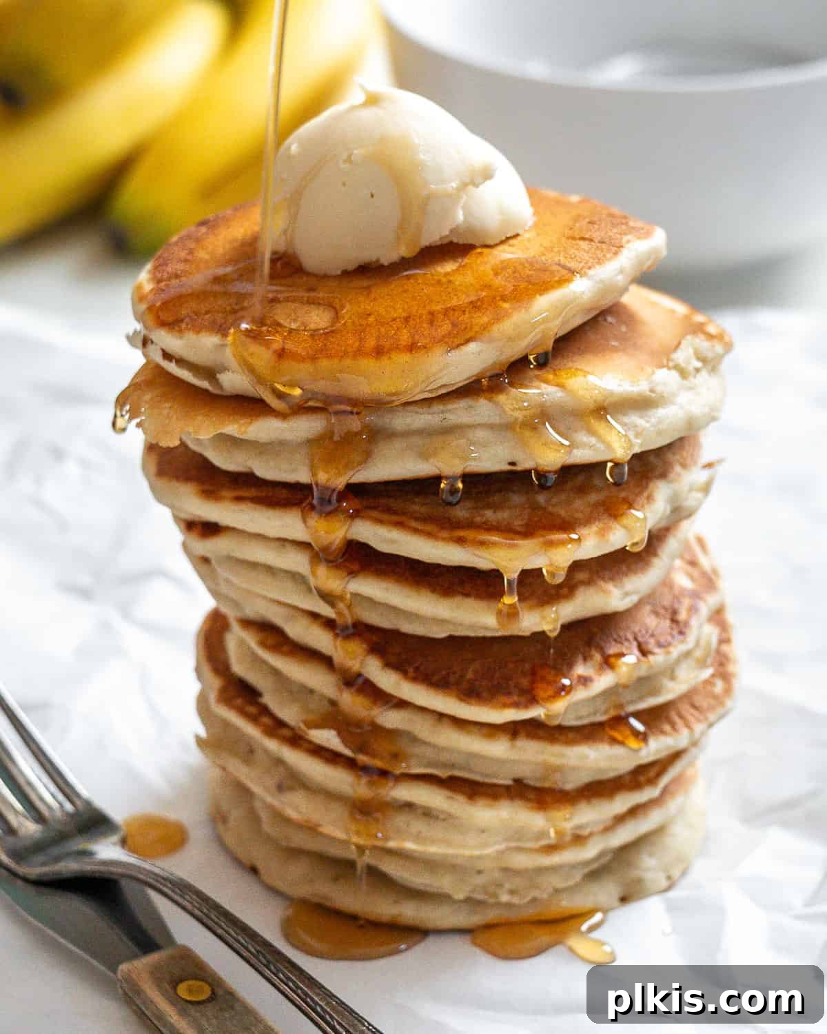 completed stack of pancakes against a white surface