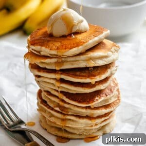 completed stack of pancakes against a white surface