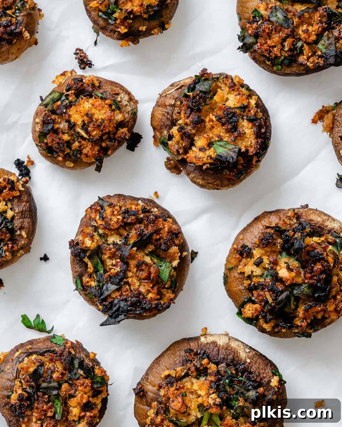 Beautifully arranged Easy Vegan Stuffed Mushrooms on a clean white platter, garnished with fresh herbs, ready to be served at any gathering.